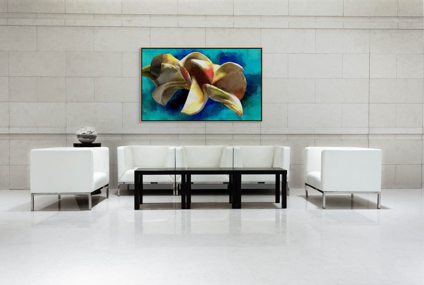 A modern, minimalist lobby showcases white chairs and a black coffee table against a light stone wall. Centered on the wall is Blossoming Thought, a Giclee art print of an abstract flower in blue and yellow shades, infused with eco-solvent inks for vibrancy.