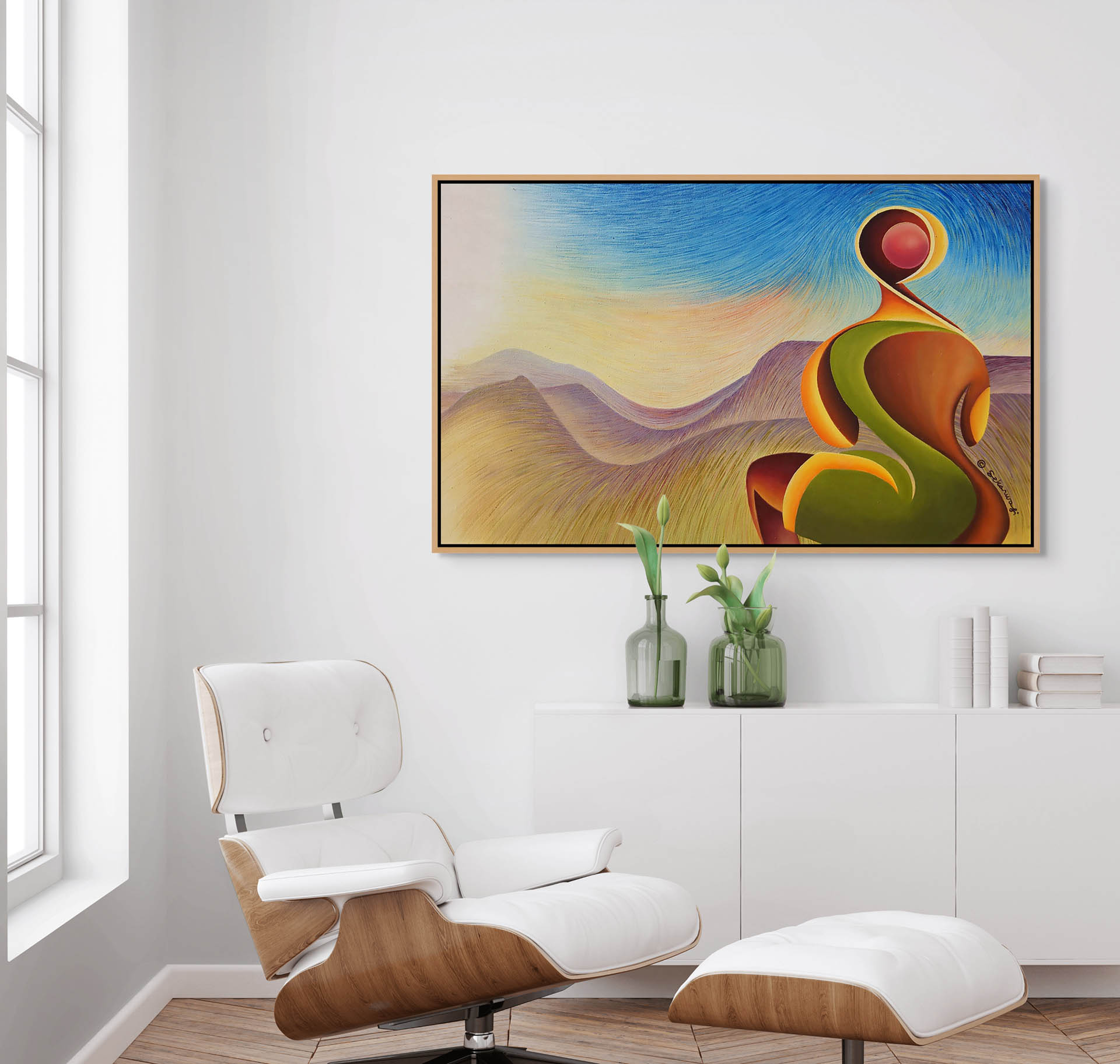 A modern living room features a white lounge chair and ottoman. Above the white console with vases of greenery, the Dawn Of A New Century African expressionist canvas art print, depicting a surreal landscape with swirling shapes, hangs under large windows that invite natural light.