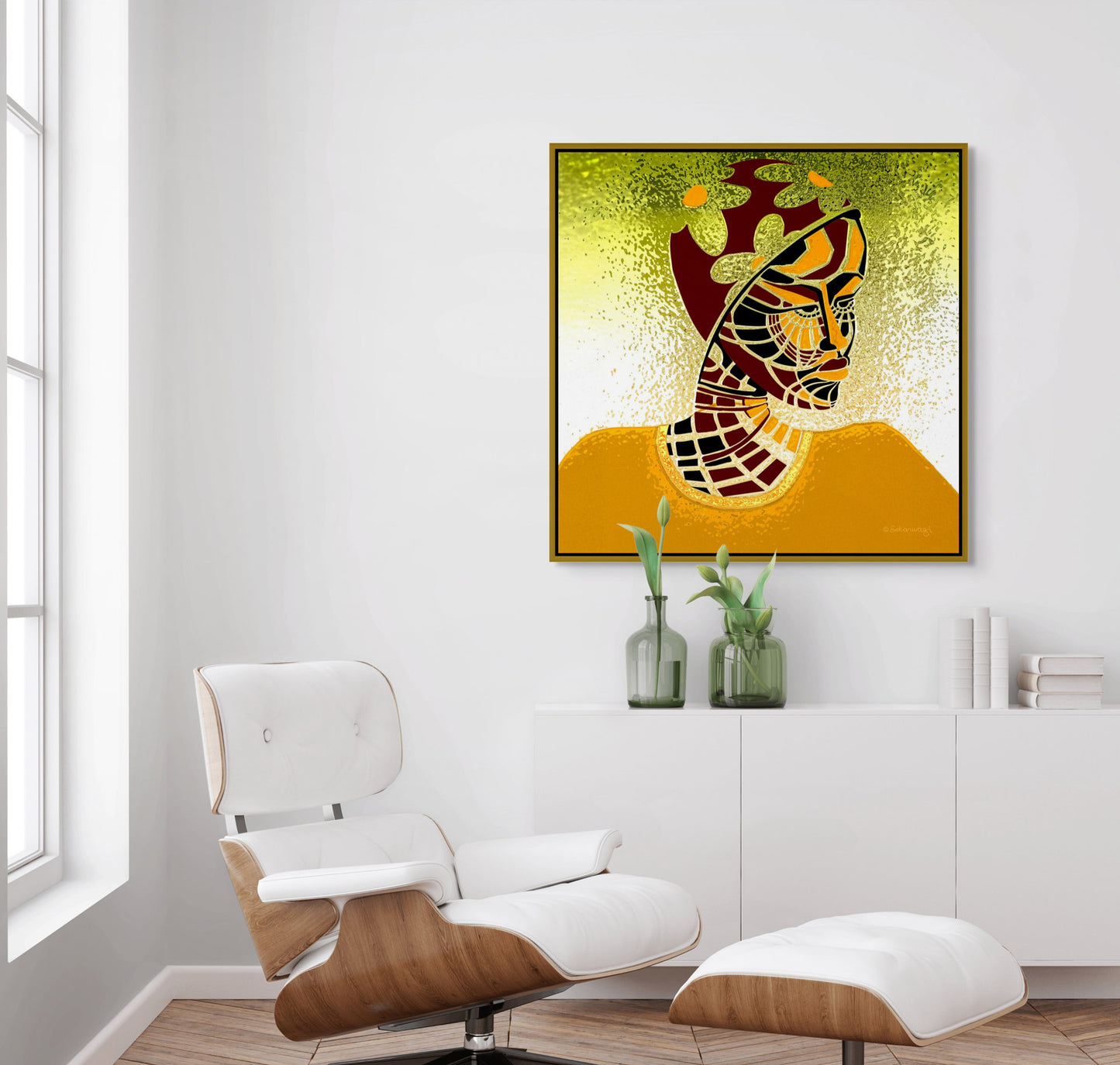 A minimalist living room with a white lounge chair and footrest. The Elements Of Beauty - Contemporary African Minimalist Canvas Art, with a stylized face and geometric patterns, hangs on the wall. Below it, a sleek white table holds two green vases with lush plants, adding nature to the scene.