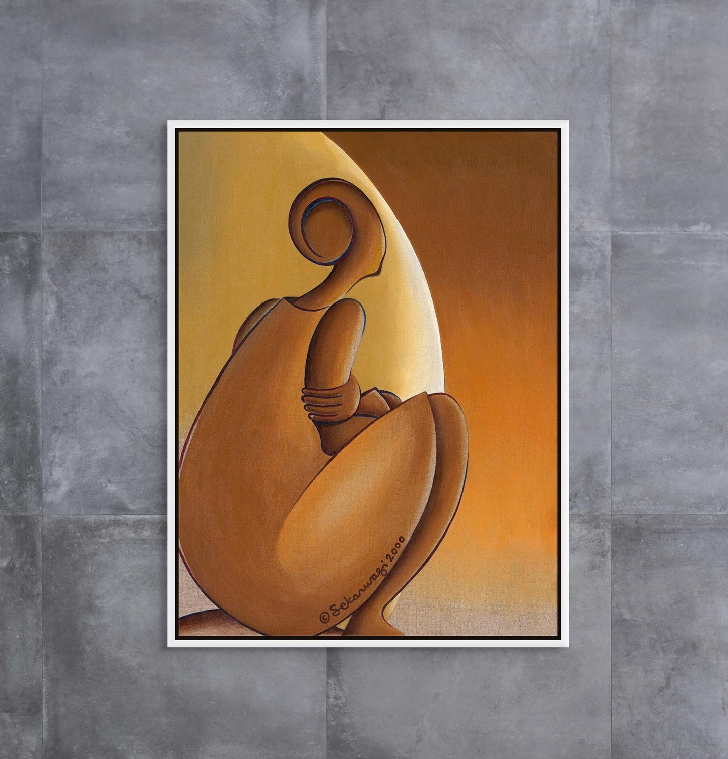 "Patience" - Contemporary African Minimalist Canvas Art Print with a white floater frame is an abstract seated figure with a curved back in brown hues against a yellow-orange gradient, mounted on a gray textured wall for a striking presence.
