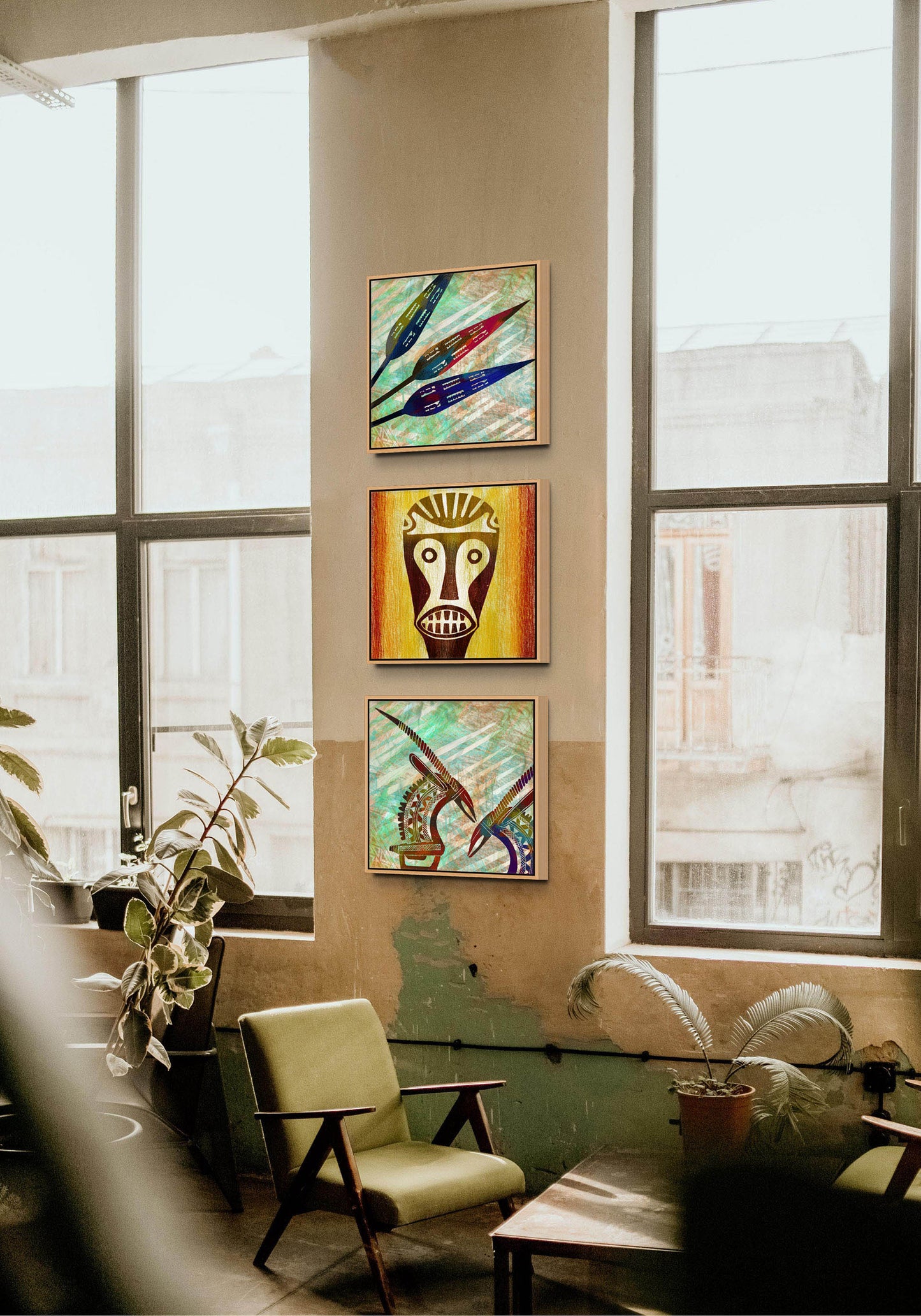 A cozy room with large windows features a green armchair. The beige wall displays Antelopes - Canvas Art, showcasing vibrant colors and bold shapes. Potted plants throughout add a touch of nature.