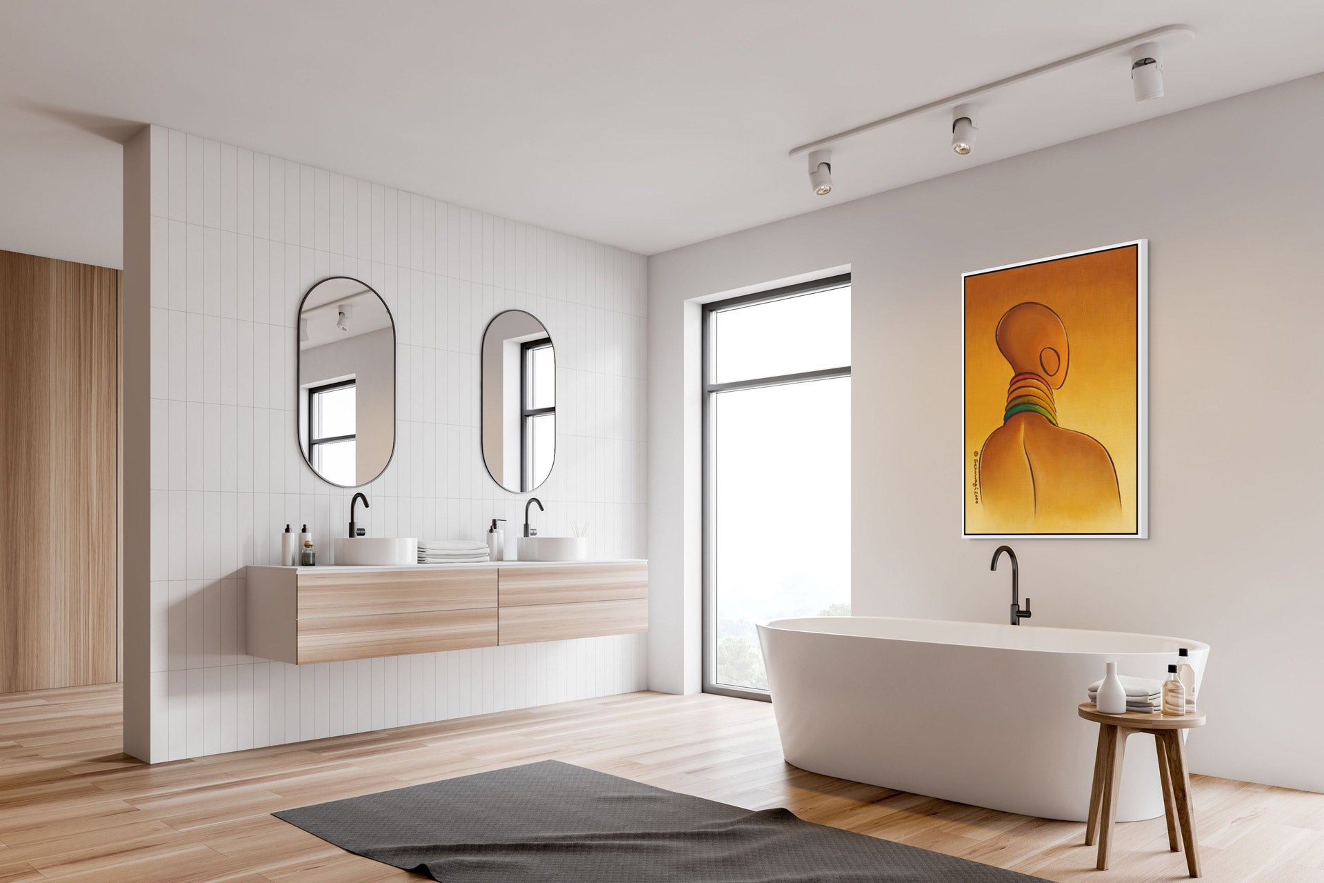 A minimalist bathroom with light wood flooring features a freestanding white bathtub, a small wooden stool, and a double sink with oval mirrors. Natural light pours through a large window, while the Elegance - Contemporary African Minimalist Canvas Art Print adorns the wall.