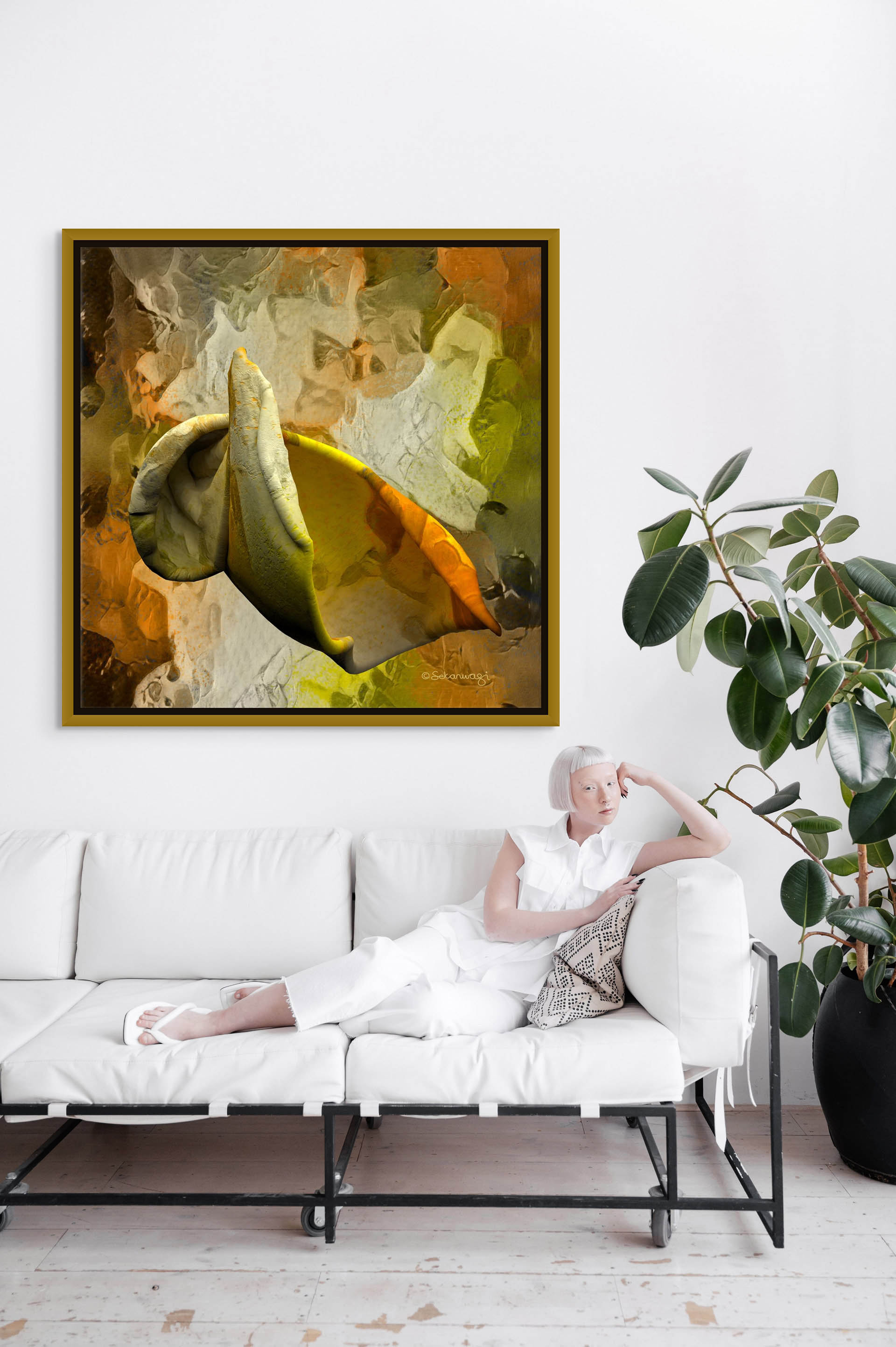 With short white hair and dressed in an all-white ensemble, a person relaxes on a white sofa. Above, Emerging Thought canvas art bursts with green, orange, and brown hues on the pristine wall. A leafy plant nearby adds a touch of nature to the serene setting.