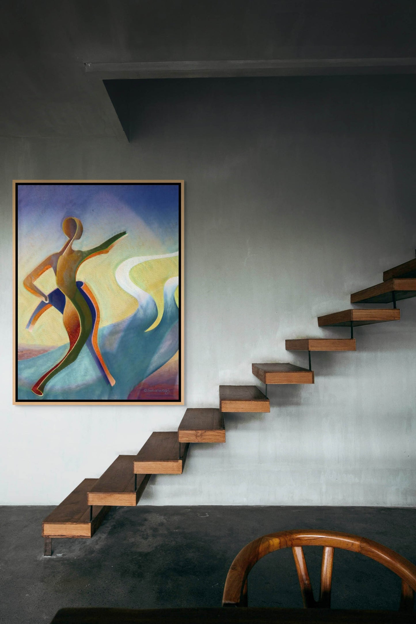 A modern interior features a floating wooden staircase against a gray wall, highlighted by Fork In The Road - Canvas Art, a colorful abstract painting of a human figure in motion. This art piece adds inspiration to the sleek design. A partial view of a wooden chair is visible in the foreground.