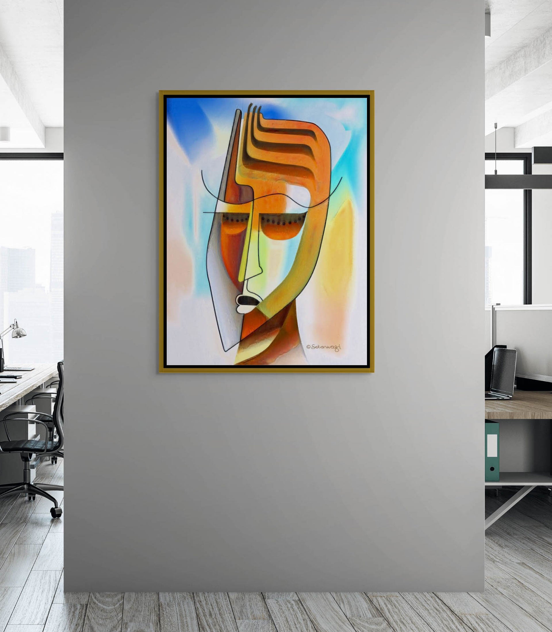 The office features Unmasking canvas art, an abstract face composed of vibrant geometric shapes in orange, blue, and green. Fluid lines and a mix of warm and cool tones complement the spaces large windows and minimalist furniture.