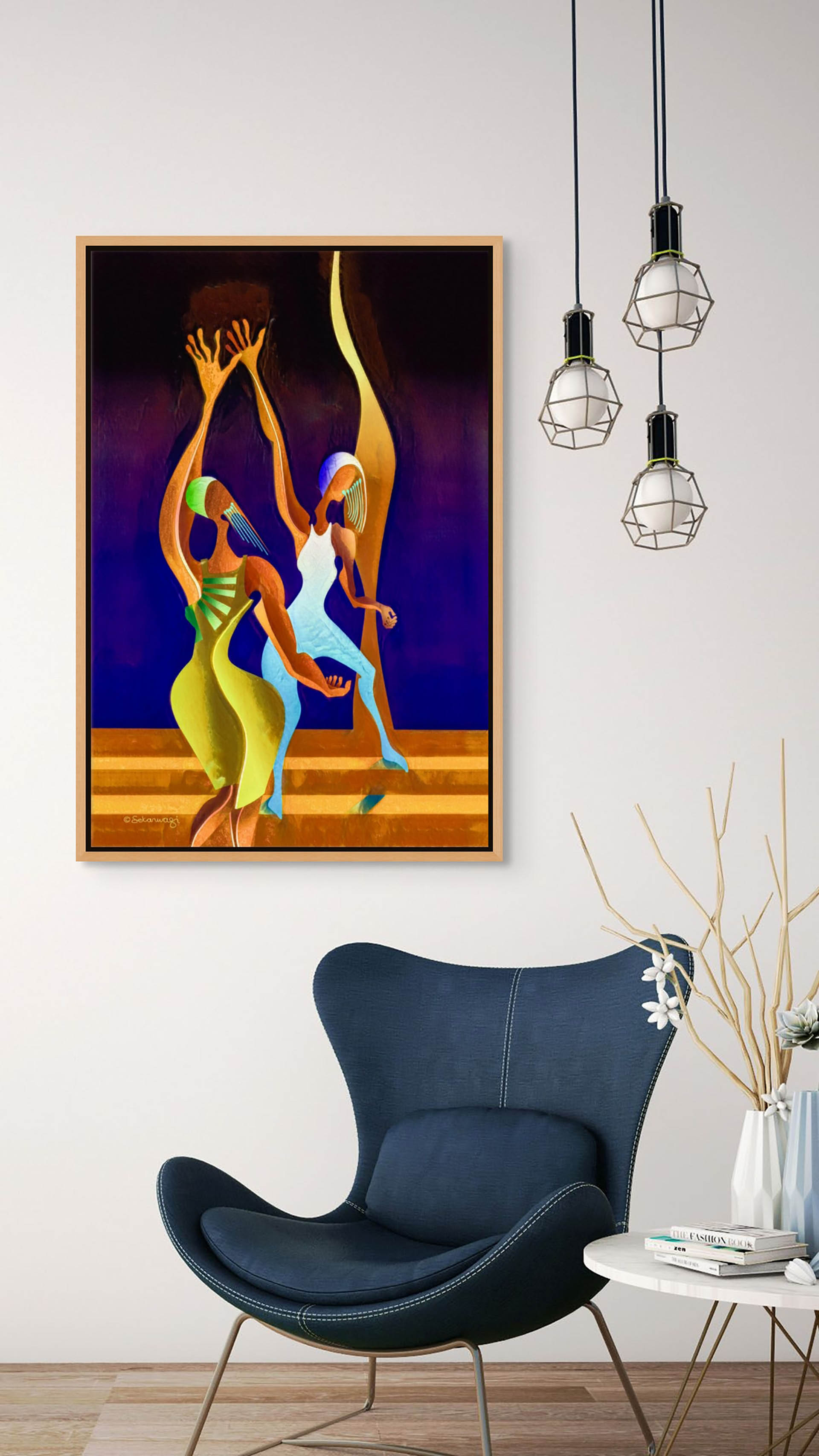In this room, a modern blue chair complements a small white table and a decorative twig vase. Above, the Victory Dance canvas art of three dancers graces the wall. To the right, three hanging light fixtures complete the scene.