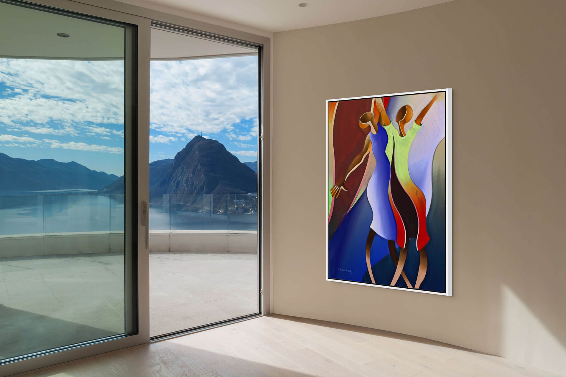 The Reaching For The Sky - Canvas Art, featuring abstract figures dancing, is displayed on a curved wall. Its ready-to-hang and enhances large glass doors leading to a balcony with breathtaking mountain and lake views under a partly cloudy sky.